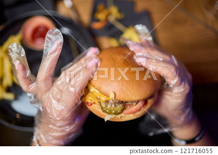 Savor a delicious gourmet burger paired with crispy fries for an unforgettable dining experience Savor a delicious gourmet burger paired with crispy fries for an unforgettable dining experience 121716055