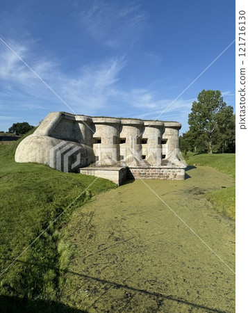 Historical Concrete Bunker by an Algae-Covered Pond Historical Concrete Bunker by an Algae-Covered Pond 121716130