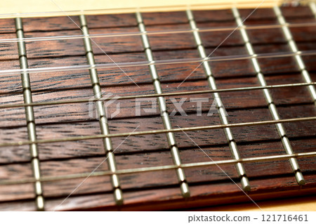 Guitar with wooden brown neck and strings. Guitar with wooden brown neck and strings. 121716461