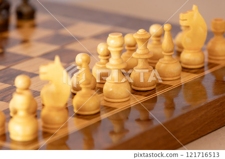 Wooden white chess pieces on the chessboard 121716513