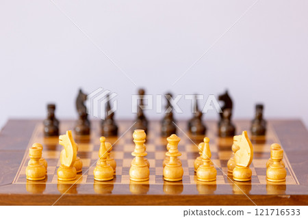 Wooden white chess pieces on the chessboard 121716533