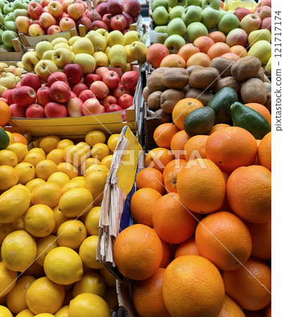 A vibrant open market stall featuring a variety of fresh fruits, including tangerines, lemons, apples, oranges, kiwis and avocado in Serbia A vibrant open market stall featuring a variety of fresh fruits, including tangerines, lemons, apples, oranges, kiwis and avocado in Serbia 121717174