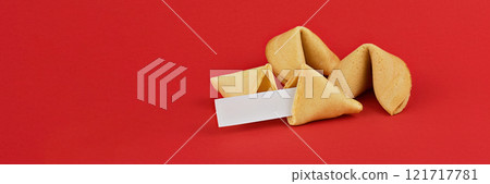 Fortune cookies on red background, featuring blank fortune slip, perfect for customization and personal messages with copy space Fortune cookies on red background, featuring blank fortune slip, perfect for customization and personal messages with copy space 121717781