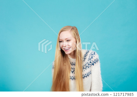 Happy woman showing her braces on teeth Happy woman showing her braces on teeth 121717985