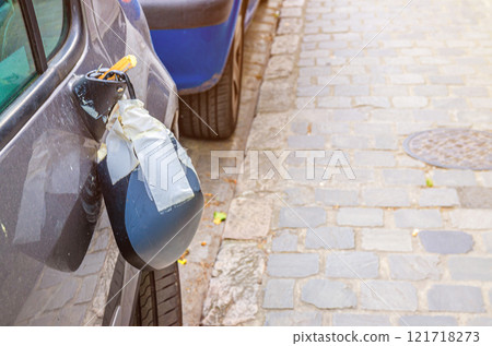 Close up view of broken car rear-view mirror or wing mirror on door Close up view of broken car rear-view mirror or wing mirror on door 121718273