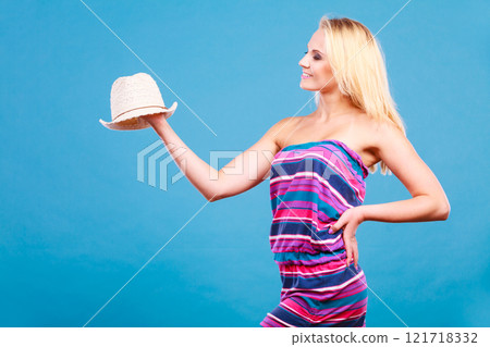 Blonde woman wearing short colorful striped dress Blonde woman wearing short colorful striped dress 121718332