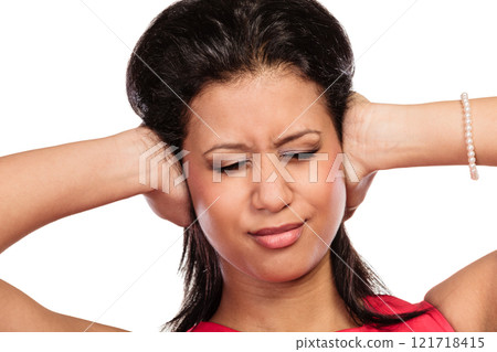 Mixed race woman closing ears with hands. 121718415