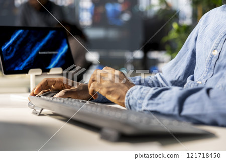 Black business manager engaged in budget analysis and strategy development at workstation, supporting objectives for company growth and employee collaboration. Strategizing business goals. Close up. 121718450