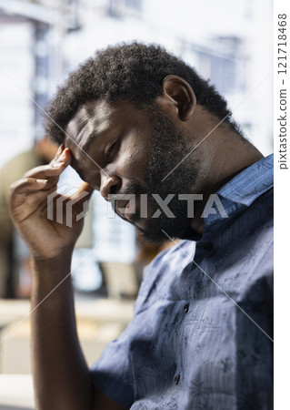 Exhausted employee rubbing forehead while analyzing datasets on computer, checking accounting figures. Tired worker suffering headache from overworking, solving tasks for team project Exhausted employee rubbing forehead while analyzing datasets on computer, checking accounting figures. Tired worker suffering headache from overworking, solving tasks for team project 121718468