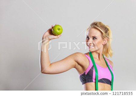 woman fit girl with measure tape and apple fruit woman fit girl with measure tape and apple fruit 121718555