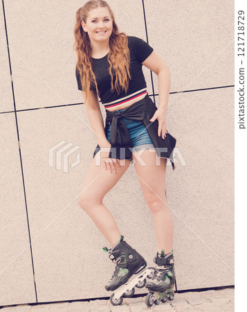 Young woman riding roller skates Young woman riding roller skates 121718729