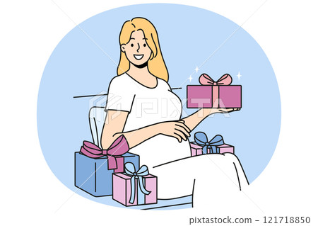 Pregnant woman with gift box strokes belly and looks at screen in anticipation of birth of baby 121718850