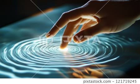 A hand is touching the surface of a touch screen, with ripples visible on its surface. 121719245
