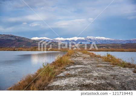 Landscape view of Salina nature park with flamingos near Ulcinj town in winter time in Montenegro Landscape view of Salina nature park with flamingos near Ulcinj town in winter time in Montenegro 121719443