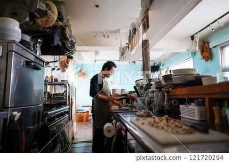 Restaurant staff cooking in the kitchen 121720294