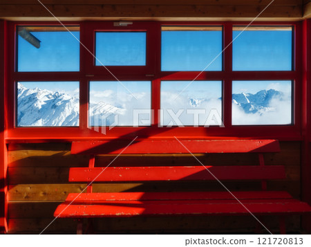Winter mountain scene through the window. High sharp rocks and snow. Cold weather and frost. Winter mountain scene through the window. High sharp rocks and snow. Cold weather and frost. 121720813