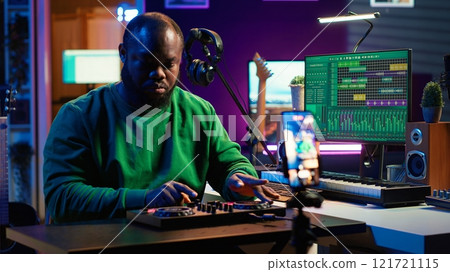 Music producer explaining faders and knobs on mixing console before teaching advanced post production stuff. Musical instructor gives advice about acoustical engineering, online vlog. Camera A. Music producer explaining faders and knobs on mixing console before teaching advanced post production stuff. Musical instructor gives advice about acoustical engineering, online vlog. Camera A. 121721115