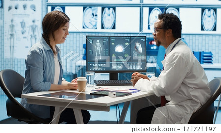 General practitioner giving the right diagnosis to woman patient, attending a checkup consultation in medical cabinet. Doctor explaining x ray imaging and scan results, care management. Camera A. 121721197
