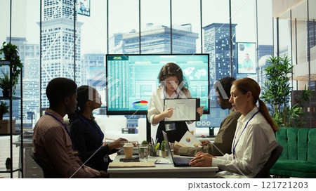 Business associates reviewing key performance indicators within the enterprise activity. Conducting evaluations and discuss training to foster development, enhance team efficiency. Camera B. Business associates reviewing key performance indicators within the enterprise activity. Conducting evaluations and discuss training to foster development, enhance team efficiency. Camera B. 121721203