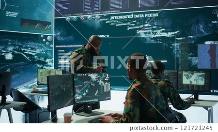 Military officer leads cybersecurity efforts in a high tech control center, ensuring data protection and managing surveillance systems, Coordinating national security operations. Camera B. Military officer leads cybersecurity efforts in a high tech control center, ensuring data protection and managing surveillance systems, Coordinating national security operations. Camera B. 121721245