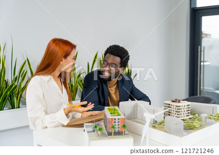 Colleagues working together on the project in the architect office 121721246