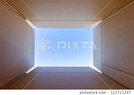 Looking up at the blue sky from inside a cardboard box Looking up at the blue sky from inside a cardboard box 121721287