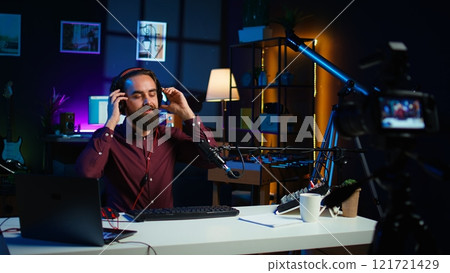 Tech expert testing headphones, mouse and keyboard, reviewing them for online streaming platforms. Internet show host presenting audio device and computer peripherals, camera B 121721429