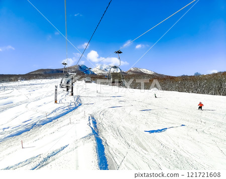A skier skiing down a ski slope 121721608
