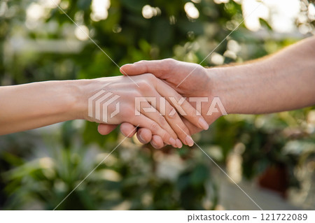 Close up picture of two hands in a handshake 121722089