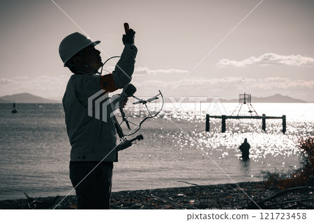 Workers surveying using a drone Workers surveying using a drone 121723458