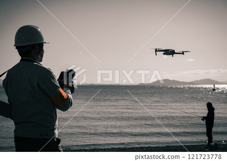 Workers surveying using a drone 121723778
