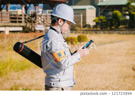 Workers flying drones 121723894