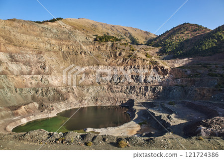Old open mining pit with pond in mountain Old open mining pit with pond in mountain 121724386