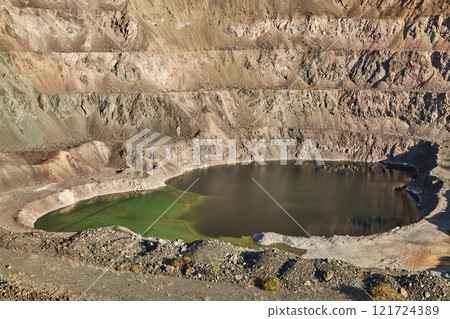 Old open mining pit with pond in mountain 121724389