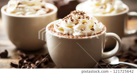 Hot chocolate or coffee latte in coffee mugs with brown background. Hot chocolate or coffee latte in coffee mugs with brown background. 121725642