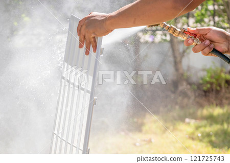 air conditioning filter cleaning with water spray 121725743