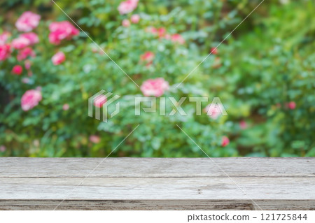 Empty wood table top with blur rose garden background for product display 121725844
