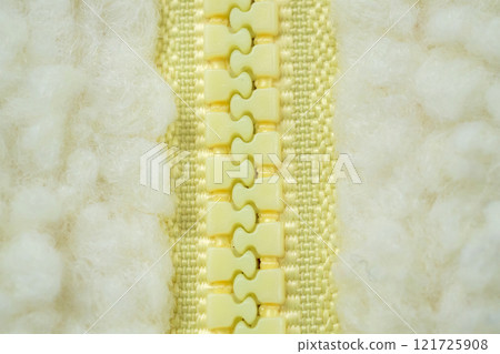 Yellow zipper on wool plush fleece fur fabric texture background Yellow zipper on wool plush fleece fur fabric texture background 121725908
