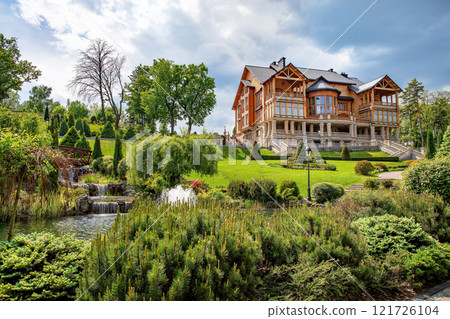 Exquisite mansion nestled in lush gardens under a vibrant sky Exquisite mansion nestled in lush gardens under a vibrant sky 121726104