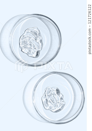 A sample of skin serum or moisturizing gel in a Petri dish. A cosmetic product. A sample of skin serum or moisturizing gel in a Petri dish. A cosmetic product. 121726122