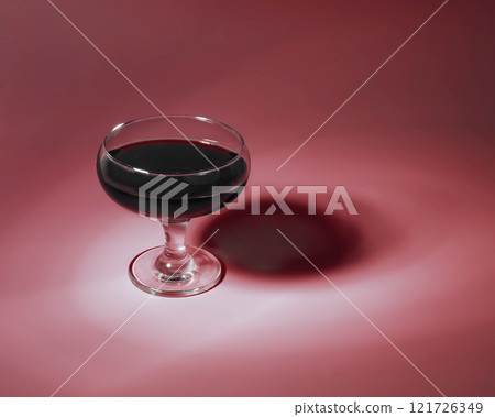 Red wine in glass on red content background with copy space Red wine in glass on red content background with copy space 121726349