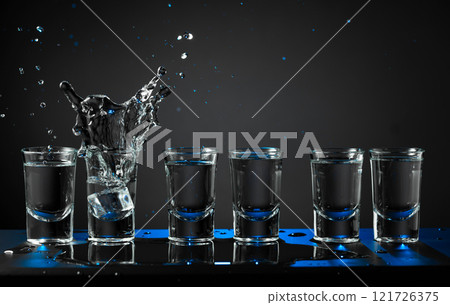 Alcoholic shots of vodka or strong drink in small glasses. Alcoholic shots of vodka or strong drink in small glasses. 121726375
