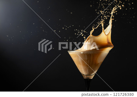 Espresso Martini drink with splashes on a black background. Espresso Martini drink with splashes on a black background. 121726380