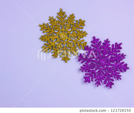 Multicolor toy snowflake glitter shiny on blue background with copyspace postcard 121726550