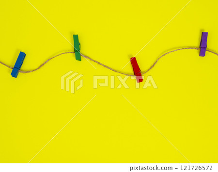 Clothes pins wooden on yellow background decorative Clothes pins wooden on yellow background decorative 121726572