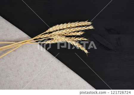 Natural wheat on craft fabric concept on dark black background with copy space 121726724