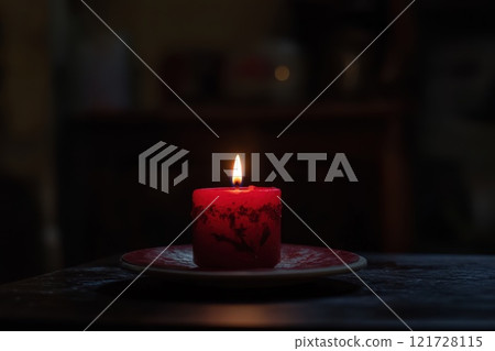 One Red Candle on a festive background. Advent, Christmas, holiday and traditions 121728115