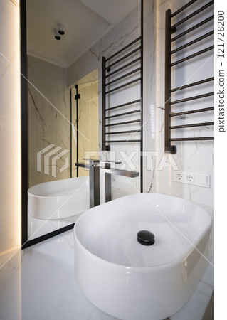 Chrome water faucet and white pedestal sink in bathroom . Stylish bathroom 121728200