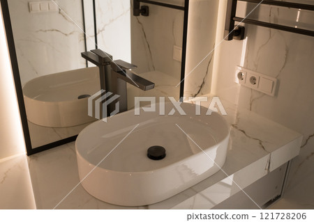 Chrome water faucet and white pedestal sink in bathroom . Stylish bathroom Chrome water faucet and white pedestal sink in bathroom . Stylish bathroom 121728206