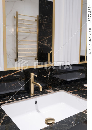 Bronze water faucet and white pedestal sink in bathroom. Stylish bathroom Bronze water faucet and white pedestal sink in bathroom. Stylish bathroom 121728234